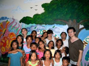 With teacher Linda and the Pak-ak Elementary School kids after painting a mural their wall.